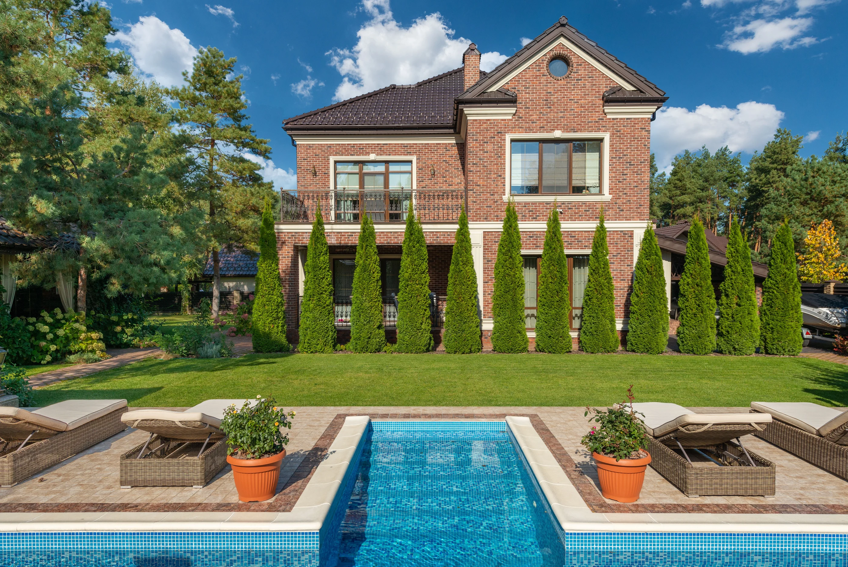 Luxury residential estate with a reflecting pool and mature landscaping
